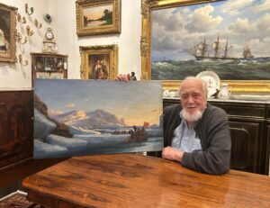 Uno Langmann holding a rennovated painting by Rasmussen